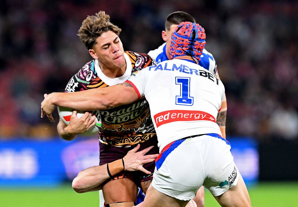 Newcastle's Kalyn Ponga tackles Brisbane's Reece Walsh on Saturday night. Picture Getty Images