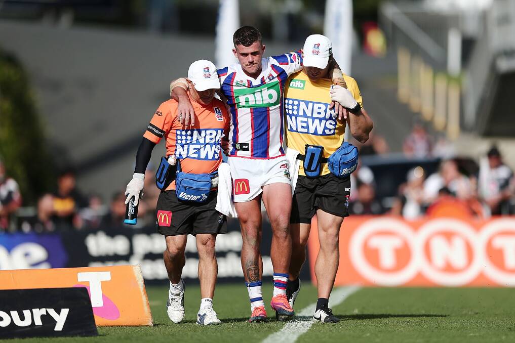 DEVASTATING BLOW: Knights fullback Dylan Phythian is helped from the field with a knee injury that is likely to end his season. Picture: Getty Images