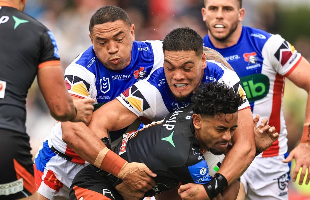 THe Knights wrap up Tigers fullback Jahream Bula. Picture Getty Images