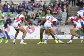 The Knights wrap up Canberra's Josh Papalii on Sunday. Picture by Gary Ramadge