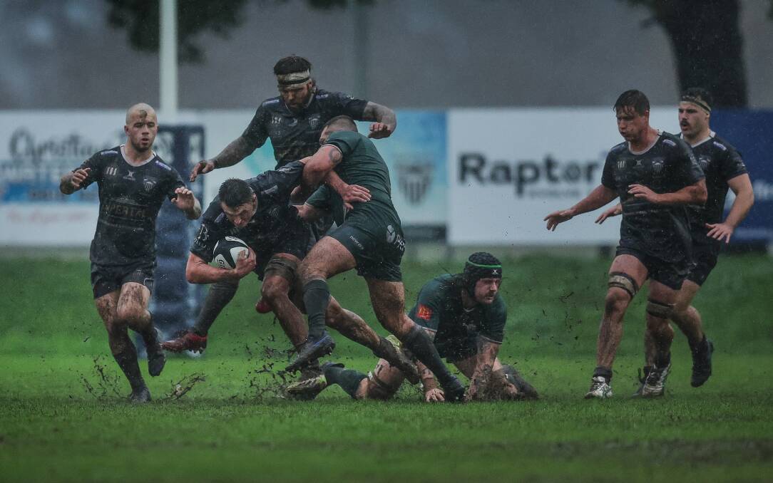 Maitland captain Sam Callow powers through the mud during the Blacks' 34-26 loss to Merewether at Marcellin Park. Picture by Marina Neil