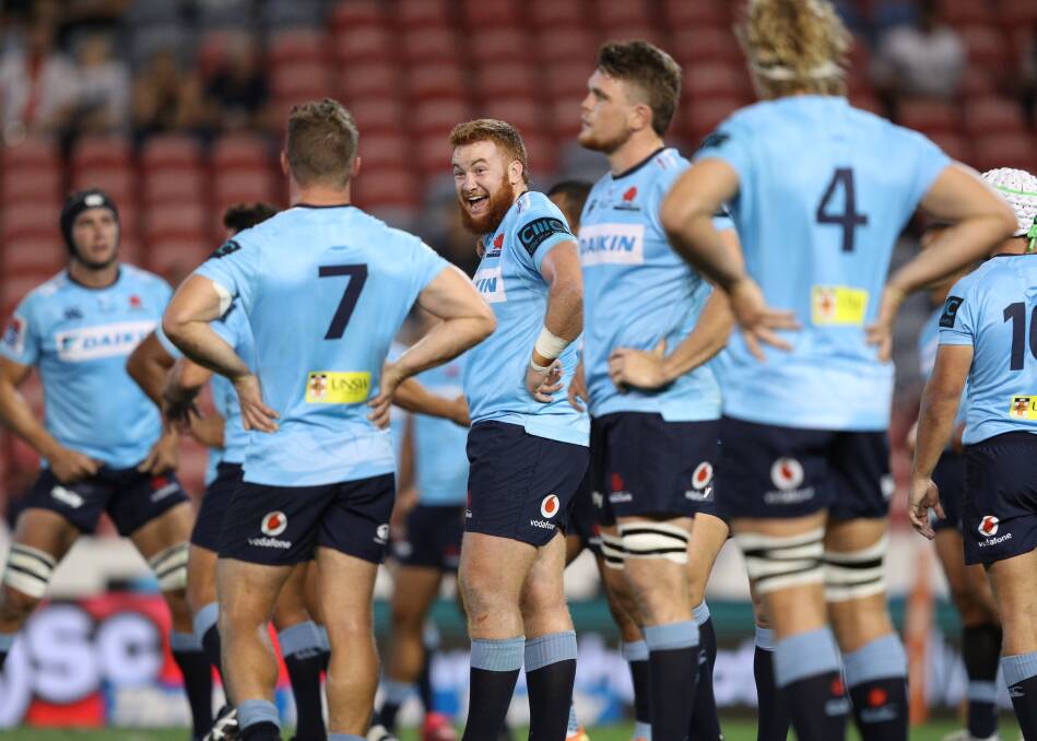 HOME COMING: Former Wanderers junior Harry Johnson-Holmes (centre) enjoys a moment during the Waratahs' clash with the Sunwolves at McDonald Jones Stadium on Friday night. Picture: Jonathan Carroll