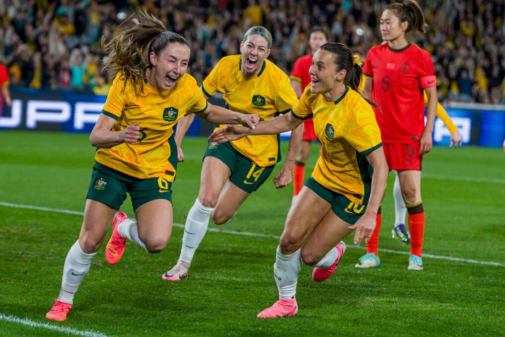 Clare Wheeler, left celebrates after scoring a goal in the Matildas' 2-0 win over China on Monday night. Wheeler and fellow Novocastrian Emily van Egmond have been named in the Matildas squad for the Paris Olympics. Picture Getty Images