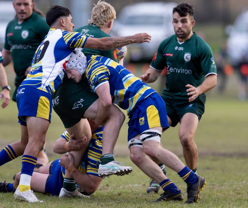 Hamilton breakaway Jack Gleeson makes a driving tackle on Merwether centre Jordan Baggs. Picture by Jonathan Carroll