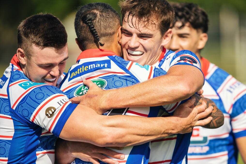 Tom Watson (left) and Connor Winchester (right) congratulate Nathan De Thierry after the centre scored a try in the Hunter Wildfires' 27-19 win over Manly at No.2 Sportsground on Saturday. 
