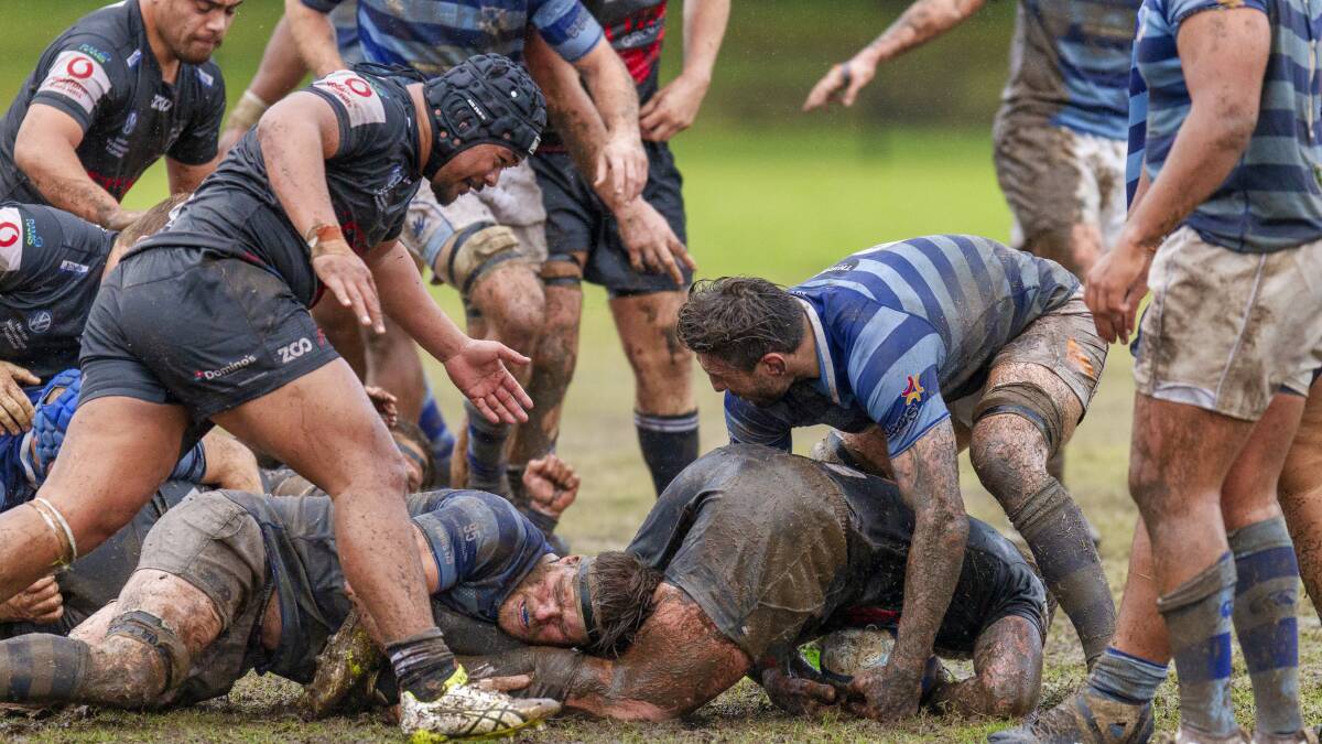 MUD BATH: Wanderers and Maitland players fight for possession in their encounter at Passmore Oval in round 10. Picture: Stewart Hazell