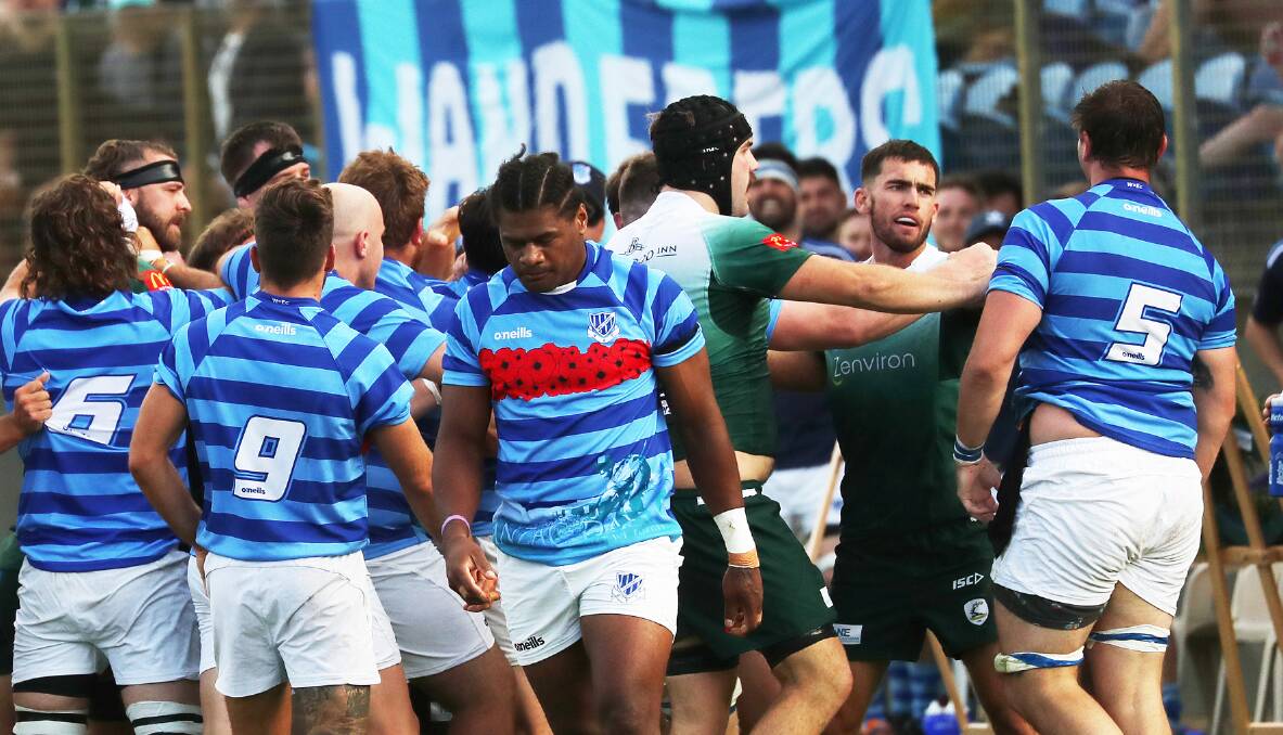 SPIRITED: Wanderers and Merewether players are separated during a melee in their Anzac Day battle at No.2 Sportsground. The Greens won a thrilling contest 24-23. Picture: Peter Lorimer