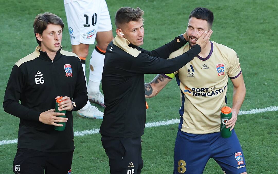 Jets assistant coach Damir Prodanovic, centre, congratulates Apostolos Stamatelopoul after the striker scored a goal. Prodanovic has agreed to another season under Rob Stanton. Picture Getty Images