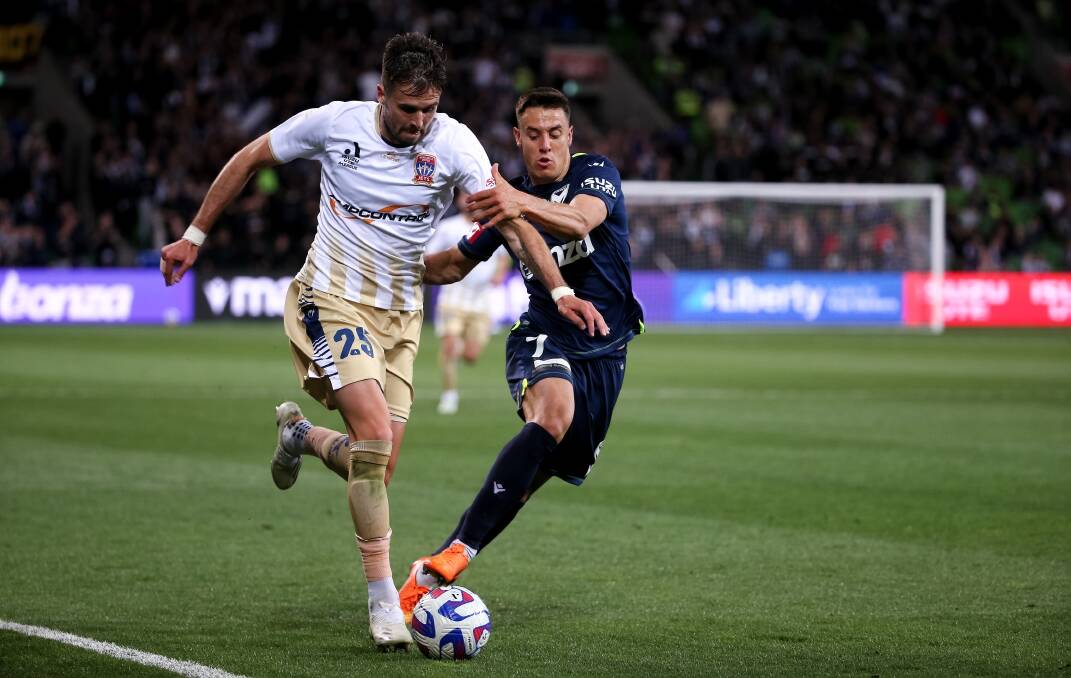 Newcastle co-captain Carl Jenkinson takes on Victory striker Chris Ikonomidis in the Jets' 4-0 loss at AAMI Park in round five. Picture Getty Images