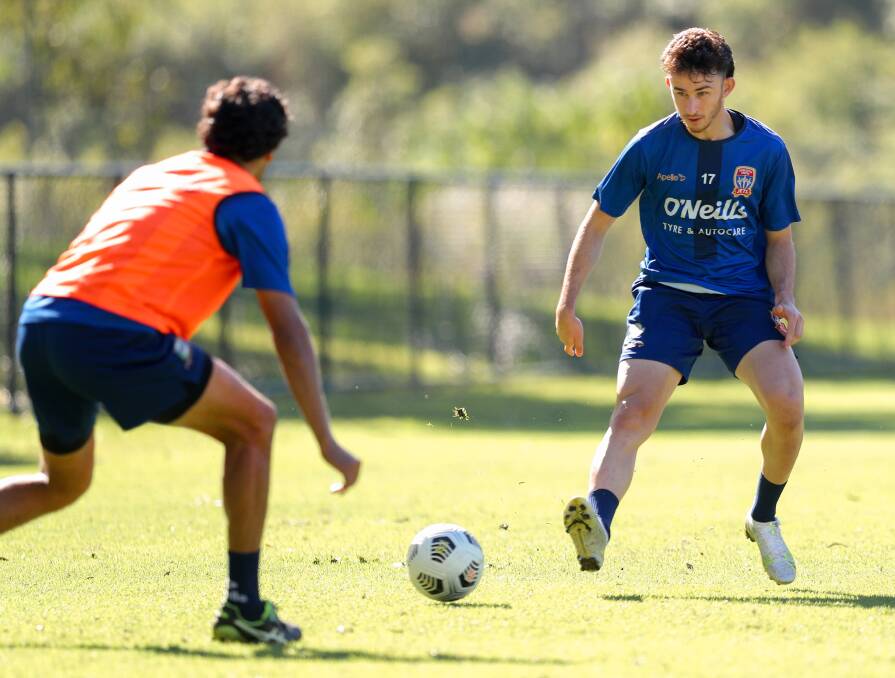 SON OF A GUN: Domenic Costanzo tries to slide a pass past Nikolai Topor-Stanley at Jets training. Picture: Max Mason-Hubers