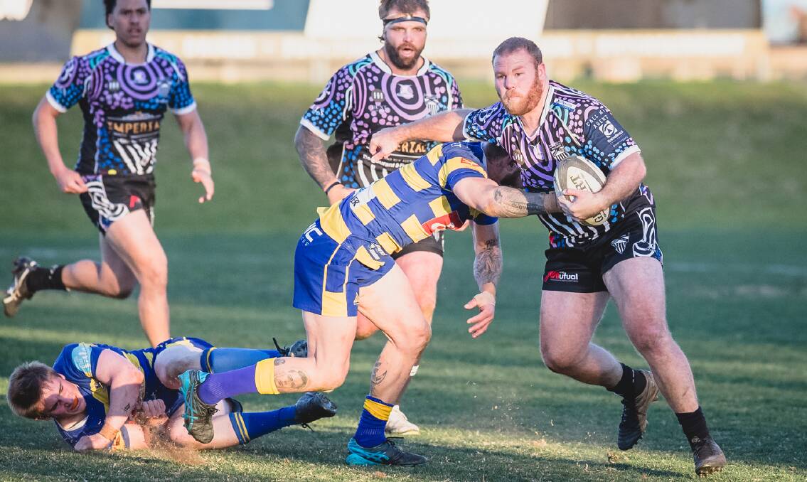 Maitland back-rower Pat Robards beats two Hamilton defenders in the Blacks' 35-29 win on Saturday. Picture by Stewart Hazell. 