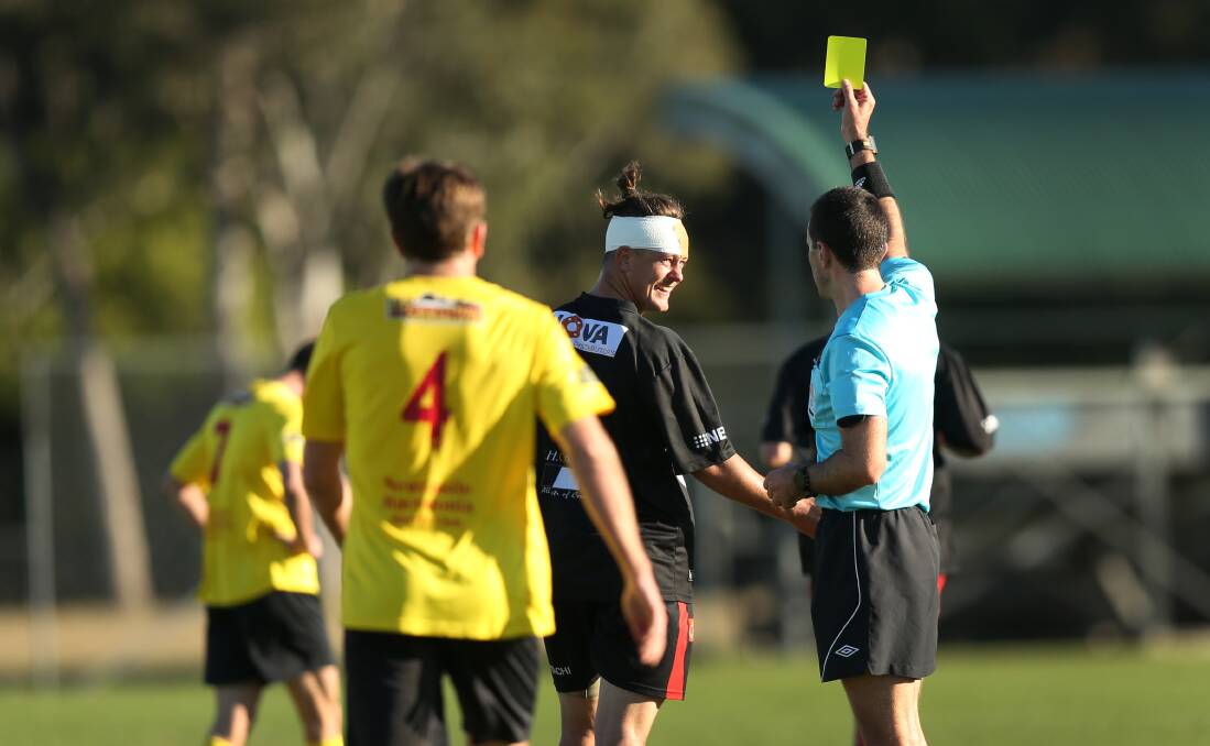 A bandaged Dylan Holz is shown a yellow card on Sunday. Picture: Marina Neil