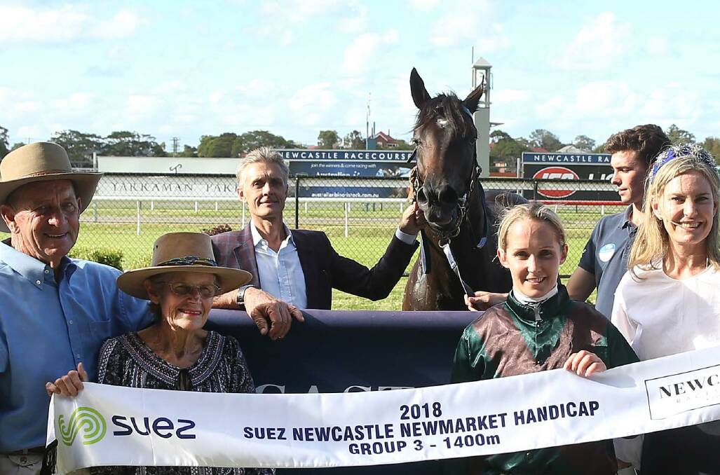 NICE RETURN: Trainer Mark Newnham, centre at back, holds Newcastle Newmarket Handicap winner Lanciato after their win at Broadmeadow in March this year. Picture: Marina Neil 