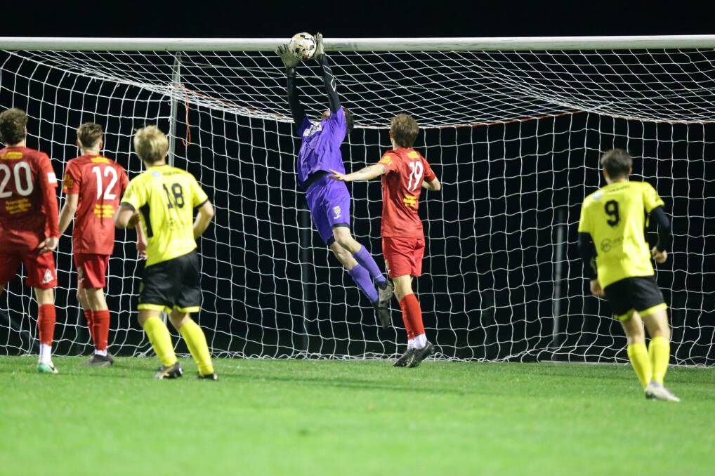Broadmeadow keeper Jack Pandel stretches to make a save on Saturday night. Picture by Jonathan Carroll