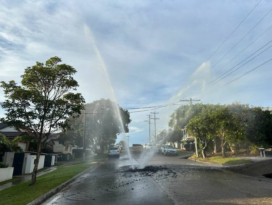 The burst water pipe in the middle of Curry Street in Merewether on Thursday morning. Picture by Caine Miller