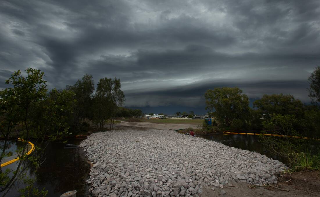 Storm clouds hover over Belmont lagoon. Picture by Jonathan Carroll