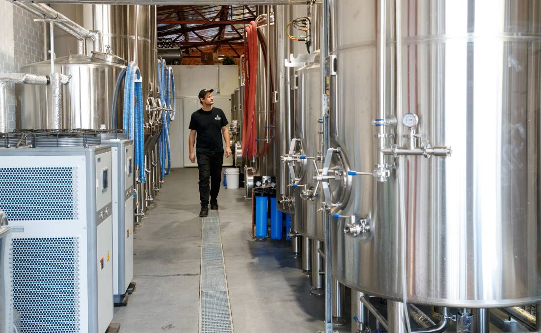 Gavin McKenzie inspecting the brewing tanks at Method. Picture: Max Mason-Hubers