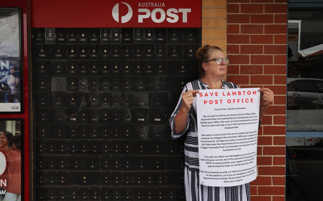 Lambton Post Office and Newsagency licensee Trish Firth with the petition to save the service. Pictures by Simone De Peak