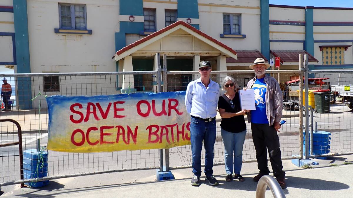 Hunter Branch National Trust chair Mark Metrikas, Karen Read from Newcastle East Residents Group and Friends of Newcastle Ocean Baths president Peter Wickham with the heritage nomination. Picture supplied
