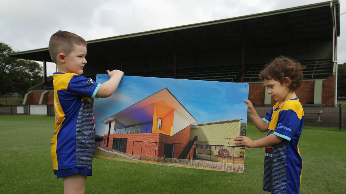 Hamish Tynan and Ada Fiore with the render of the new building which will house female changerooms. Picture by Simone De Peak