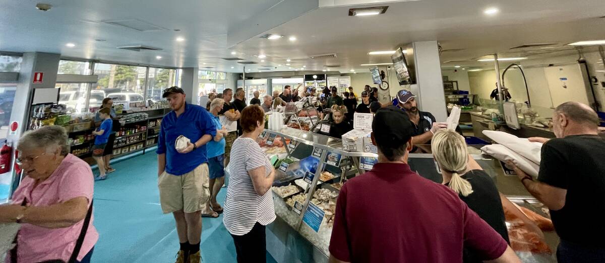 The crowd at the fish co-op on Friday morning. Picture by Michael Parris 