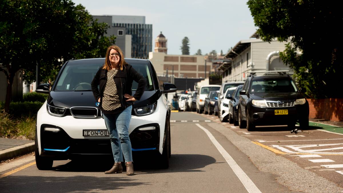 Leah Stevens with her electric BMW in Newcastle on Friday. Picture by Jonathan Carroll