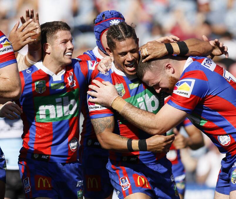 GREAT START: Knights players congratulate Tyrone Amey after he helped set up a try against the Sharks on Sunday. Picture: Darren Pateman/AAP