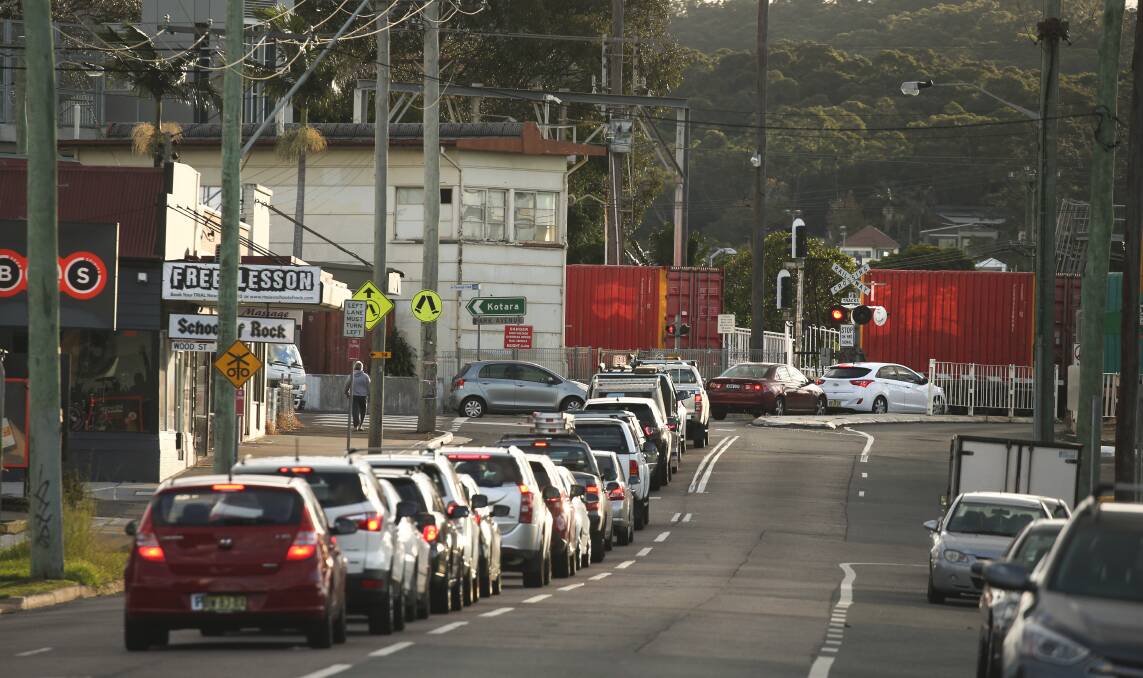 Cars queue at Adamstown level crossing as a freight train goes past. File picture 