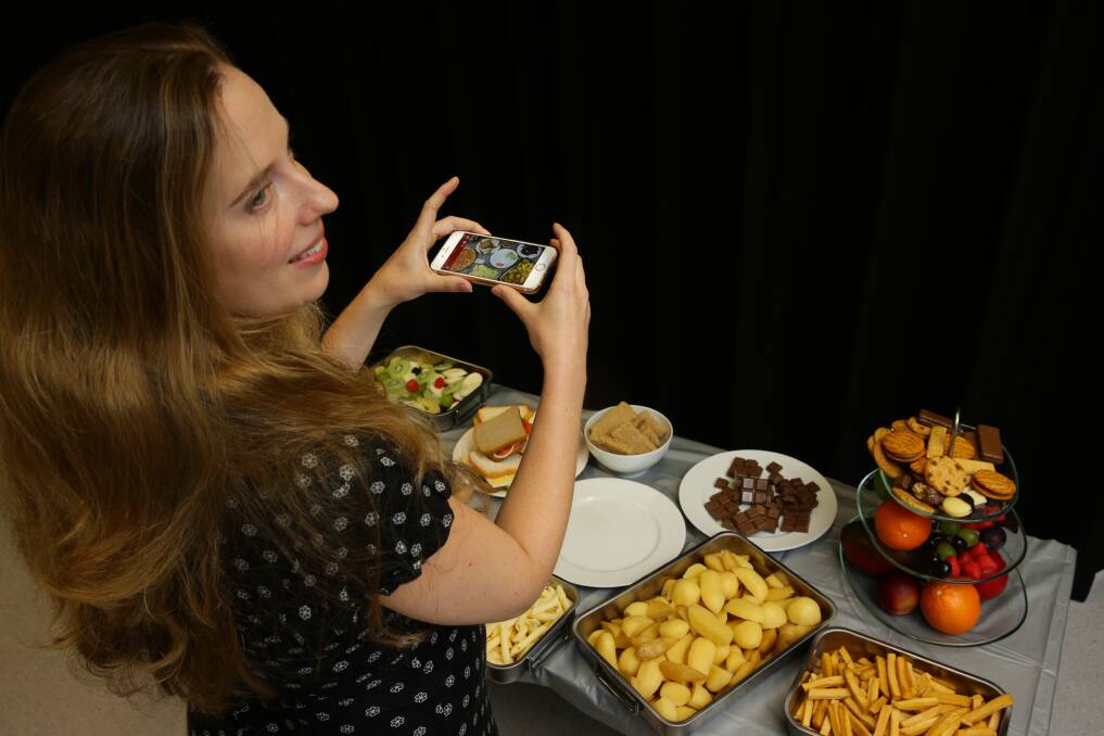 Health in hand: Amy Ashman, 20 weeks pregnant, is using an app developed by the University of Newcastle nutrition and dietetics research team to help women keep track of their diet during pregnancy. Picture: Jonathan Carroll

