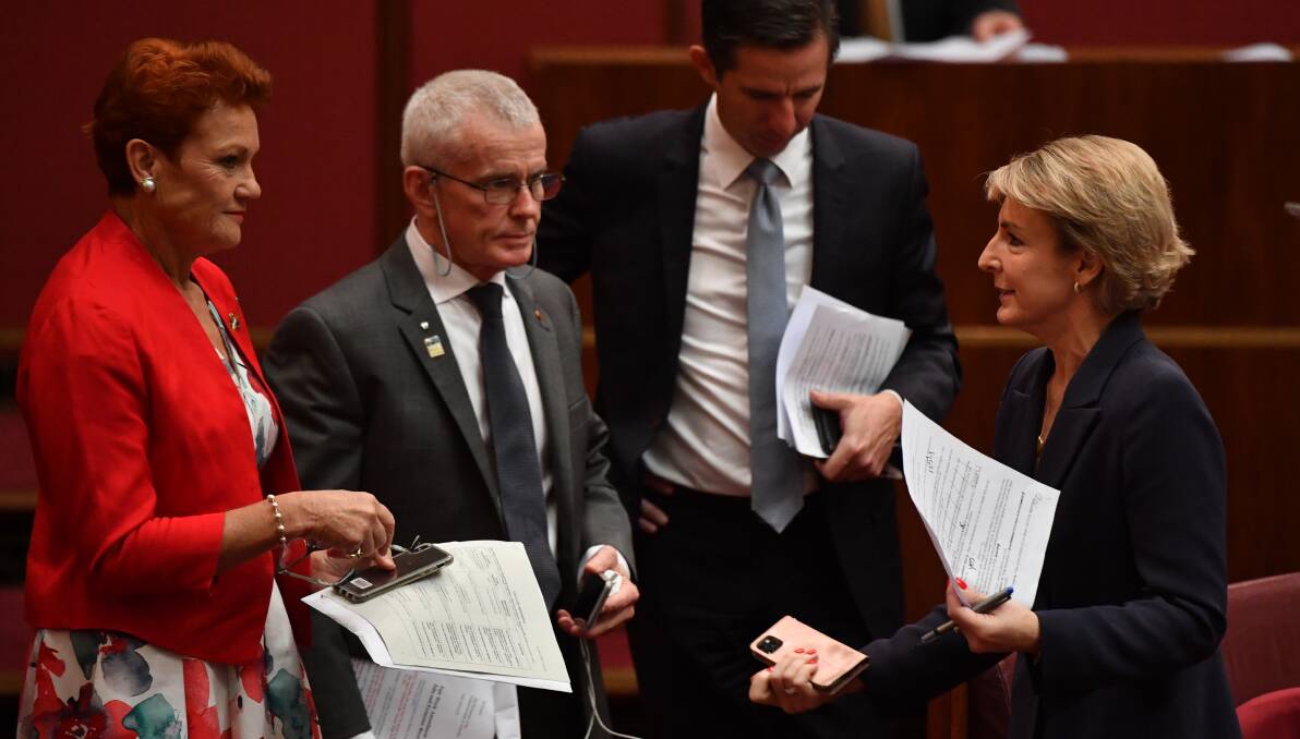 Senators Pauline Hanson, Malcolm Roberts, Simon Birmingham and Michaelia Cash talk during debate on the Fair Work Amendment Bill 2021 in the Senate on Thursday. 