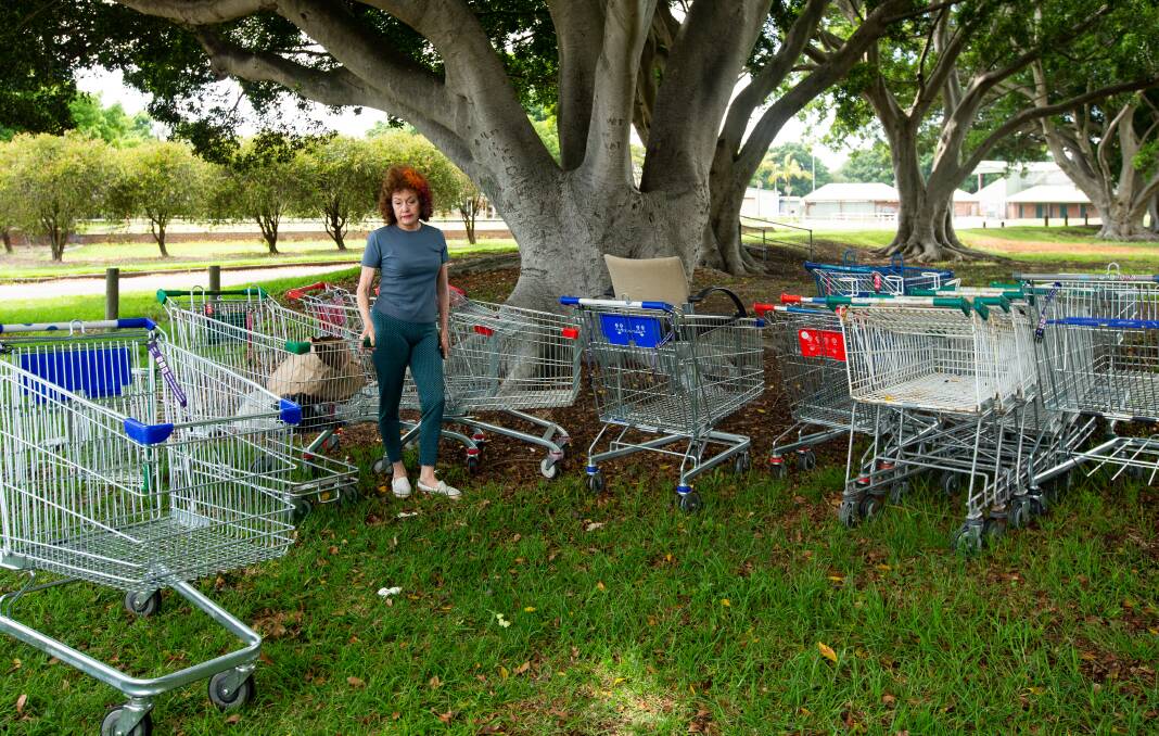 Lyn Kilby with discarded shopping trolleys in Wickham Park. Picture by Jonathan Carroll. 