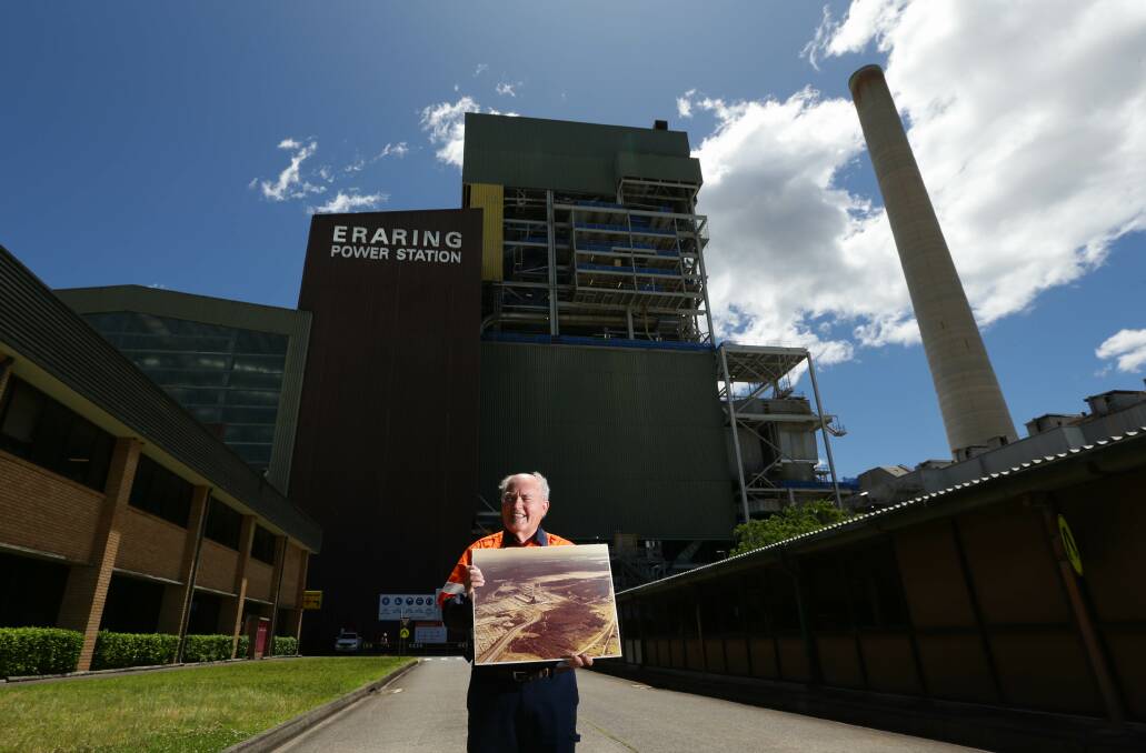 Dr Ken Thornton with one of the many archival photos of Eraring Power Station. Picture by Jonathan Carroll. 
