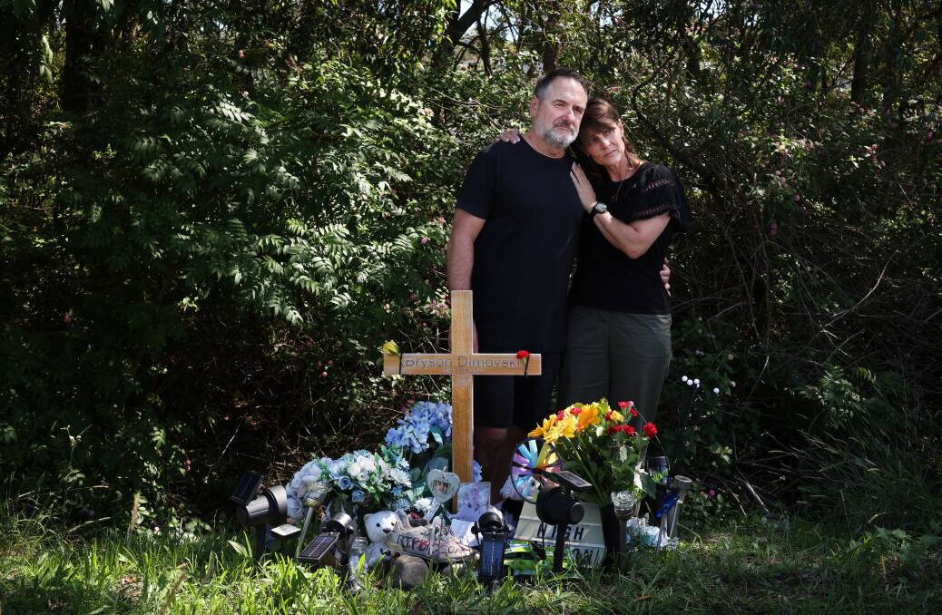 Andrew and Melissa Dimovski at the roadside memorial on Macquarie Road Warners Bay where their son Bryson was killed. Picture by Simone De Peak.