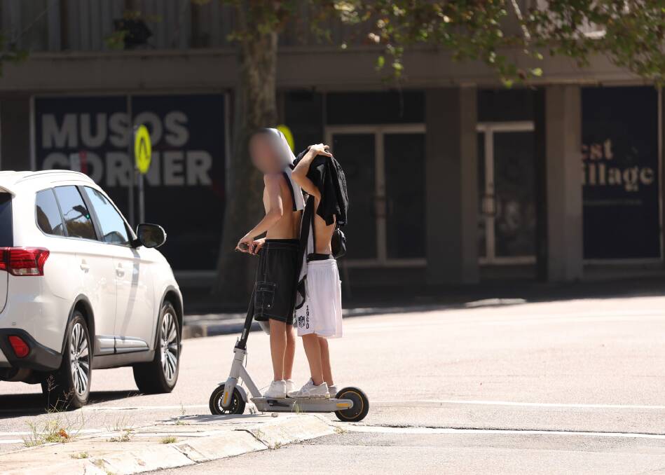 Two riders double on an e-scooter on Hunter Street earlier this year. Picture by Peter Lorimer