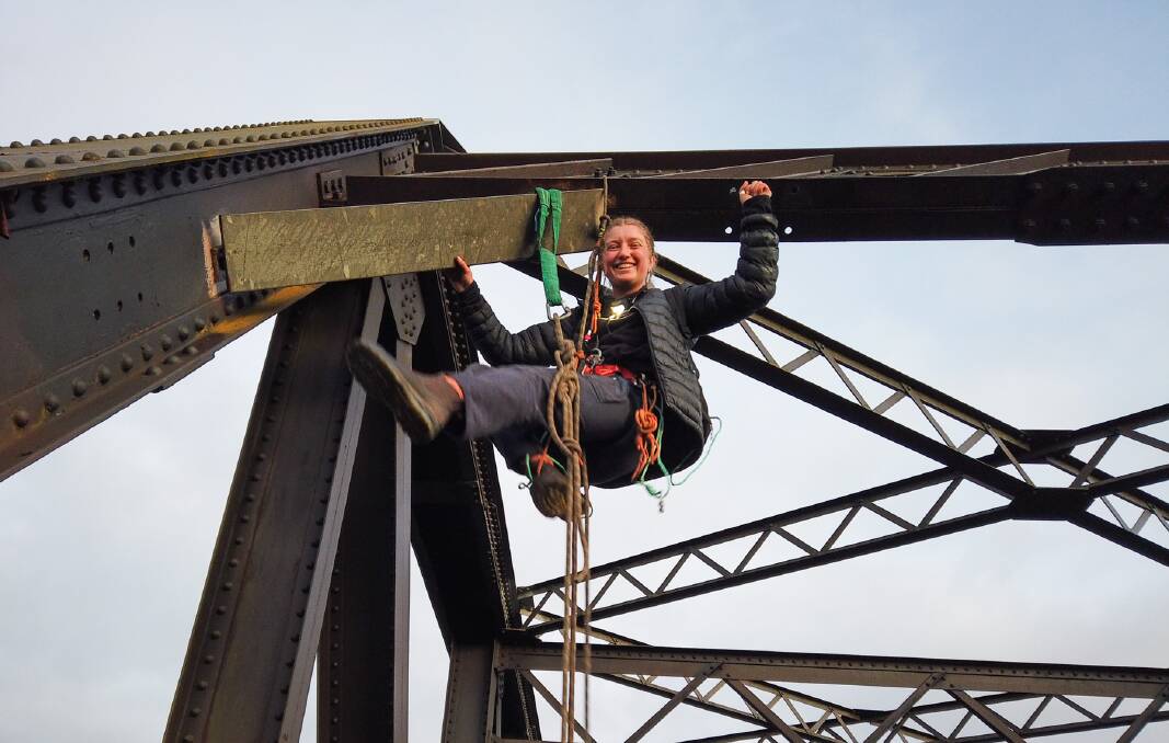 A woman was suspended on a rail bridge in the Hunter on the morning of July 5, the 11th day of protests. Picture by Blockade Australia
