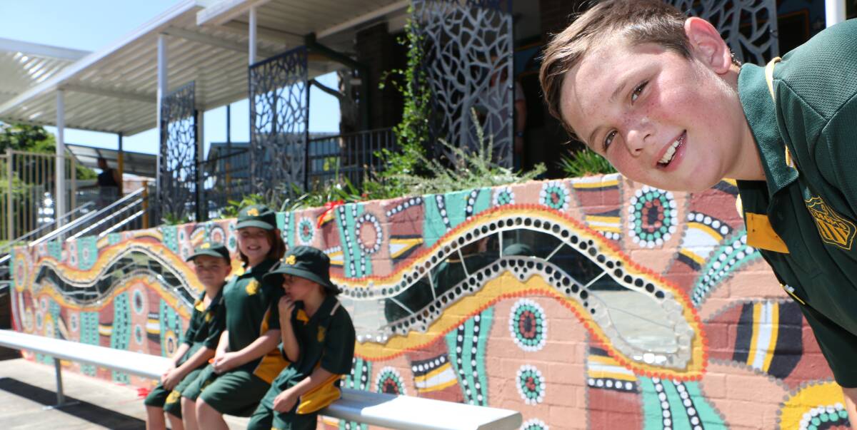 LOOKS GREAT: Toronto Public School captain Angus Ping with a delegation of fellow students from the Pondee Kids group, with their rainbow serpent creation and new garden. Picture: David Stewart