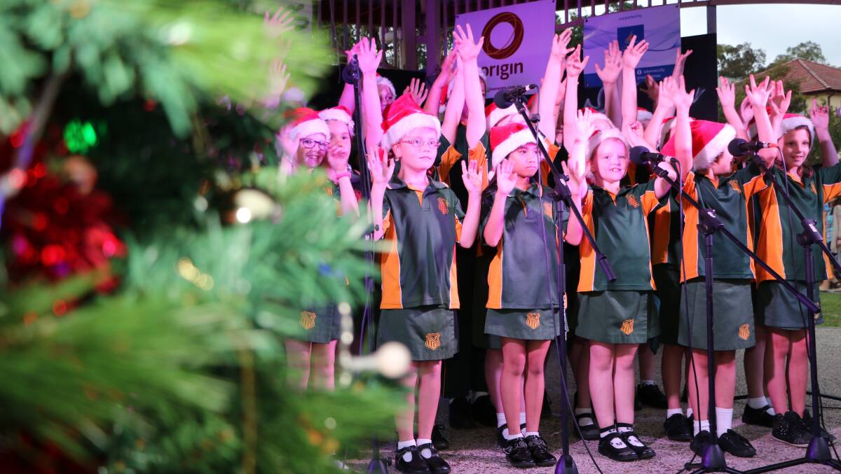 JINGLE BELLS: Toronto Public School students performing carols on the Toronto foreshore in 2014. This year, the school will host its own carols in the school grounds. Picture: Jamieson Murphy