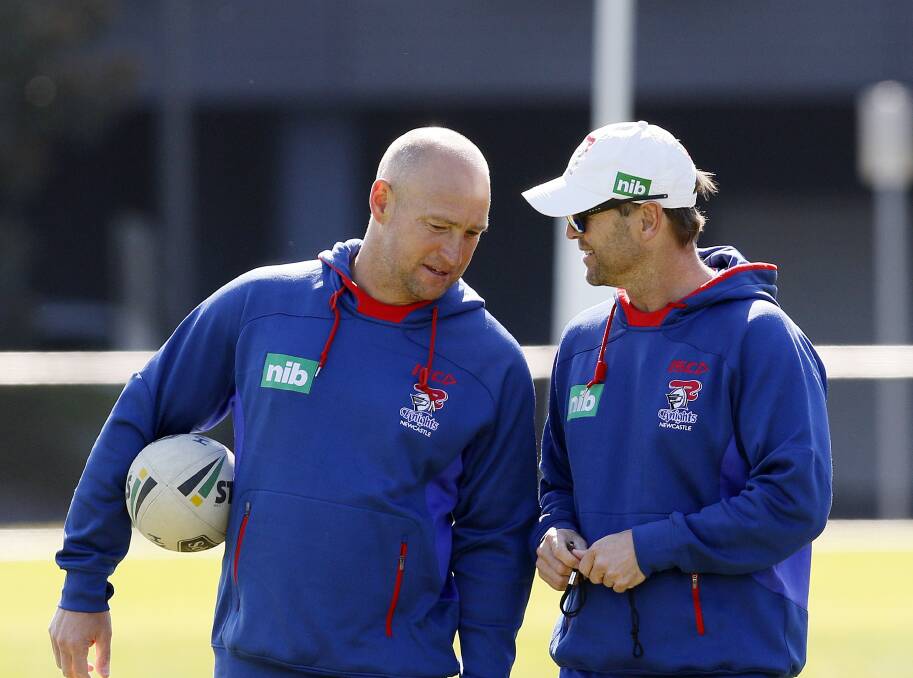 Parting ways: Knights coach Nathan Brown and his assistant Mick Potter compare notes at training on Wednesday. Potter will depart the club at the end of the season after three years in Newcastle. Picture: Darren Pateman/AAP   