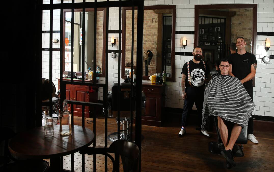 At your service: Coal & Cedar co-owner Ethan Ortlipp, right, with Lincoln Room barber Branden Evans and Elliot Pogonoski. Picture: Marina Neil.