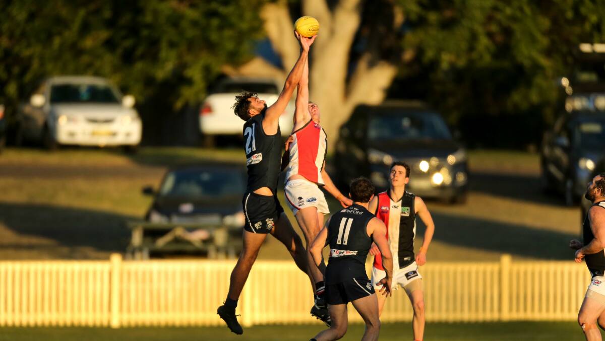 UP IN THE AIR: Newcastle City playing Terrigal Avoca in this year's Black Diamond AFL. Picture: Marina Neil
