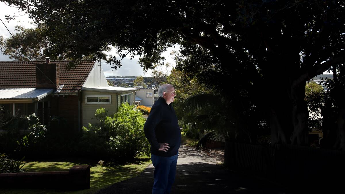 Brian Moir next to the fig tree that will be removed to make way for a $1.9 million home. Picture by Simone De Peak 