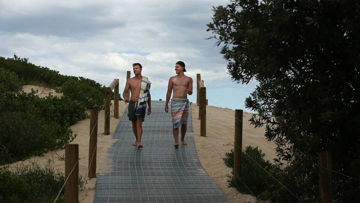 Charlie Houston of Cardiff and Jacob Carlin of Valentine using the new boardwalk. Picture by Simone De Peak.