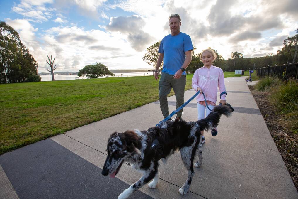 Scott Thompson with daughter Matilda, 7 and their dog Hank at Thomas H Halton Park. Picture supplied