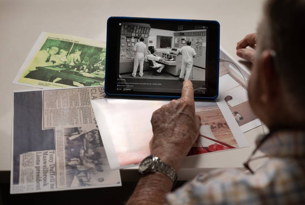 Tony Duffell looks at old photographs from his time at Liddell. Picture by Marina Neil 