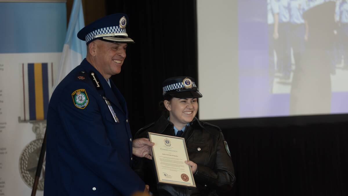 Acting Assistant Commissioner Shane Cribb presents Senior Constable Felicity Birt with her award. Picture by Jonathan Carroll 