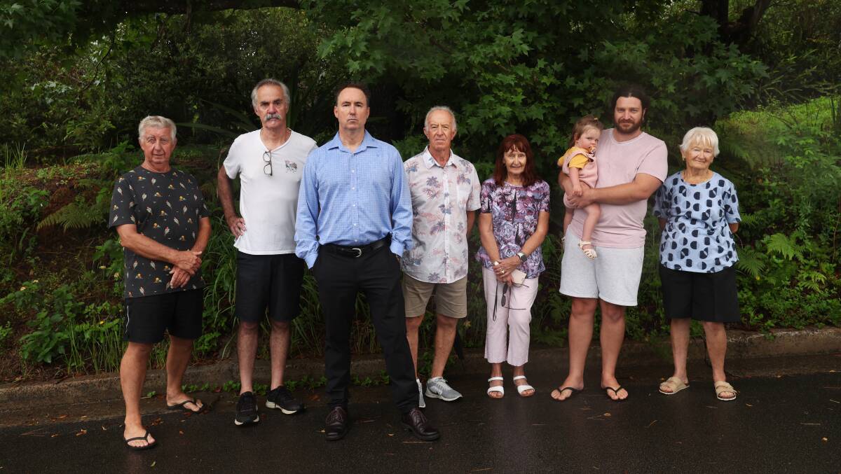 Second in from left, Len Biglin and Paul Chaplin with other Princes Avenue residents who oppose the development. Picture by Simone De Peak 
