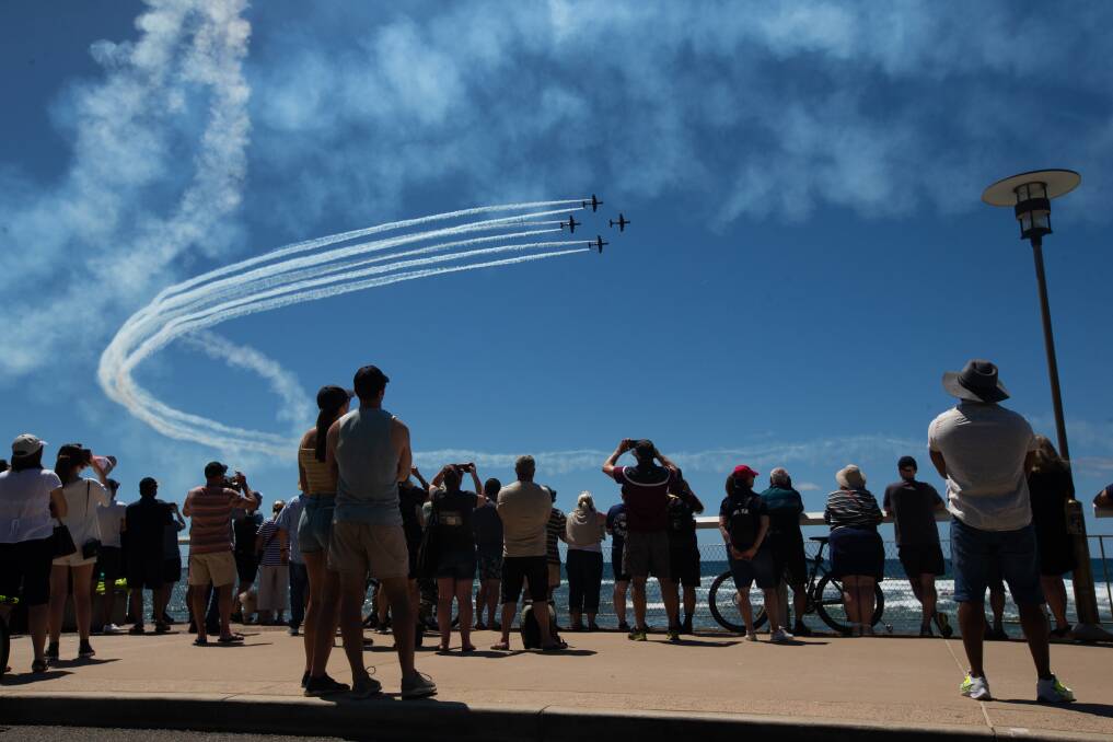 Observers watching Saturday's aerobatics from Nobbys beach. Picture by Jonathan Carroll