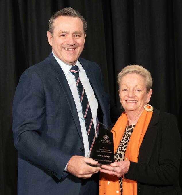 Lambton Jaffas' long-serving volunteer Jenny Bailey is presented with her NSW Sport award by NSW Sports Minister Steve Kamper on Wednesday night. Picture Supplied