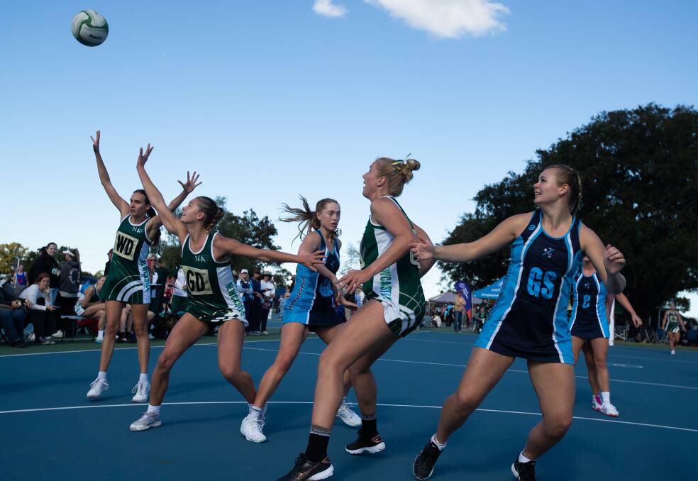 Newcastle defend desperately against Manly during the NSW senior netball championships at Maitland netball courts on Saturday. Picture by Jonathan Carroll