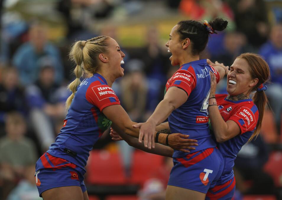 Abigail Roache, middle, celebrates a try with Jasmin Strange, left, and Caitlin Moran right. Picture by Marina Neil